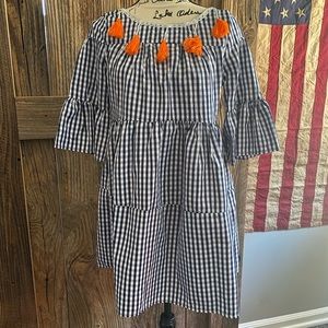 Navy/white check babydoll dress with orange tassel